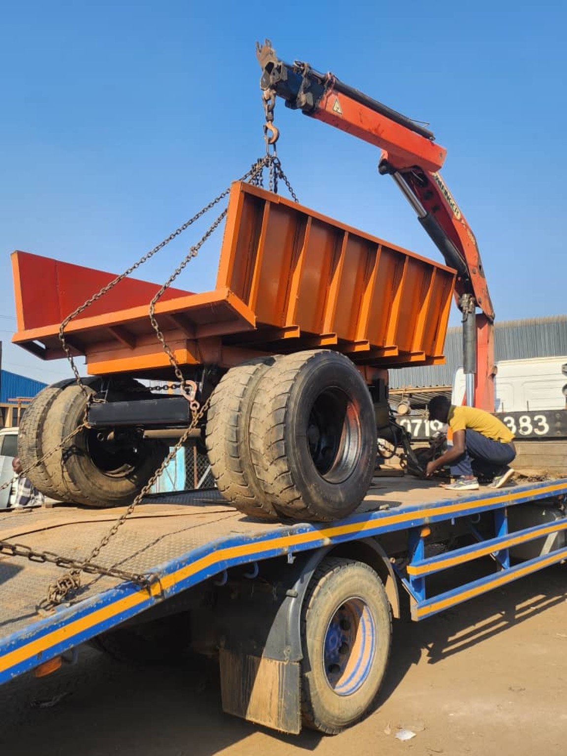 Trailer dumper being lifted for transport